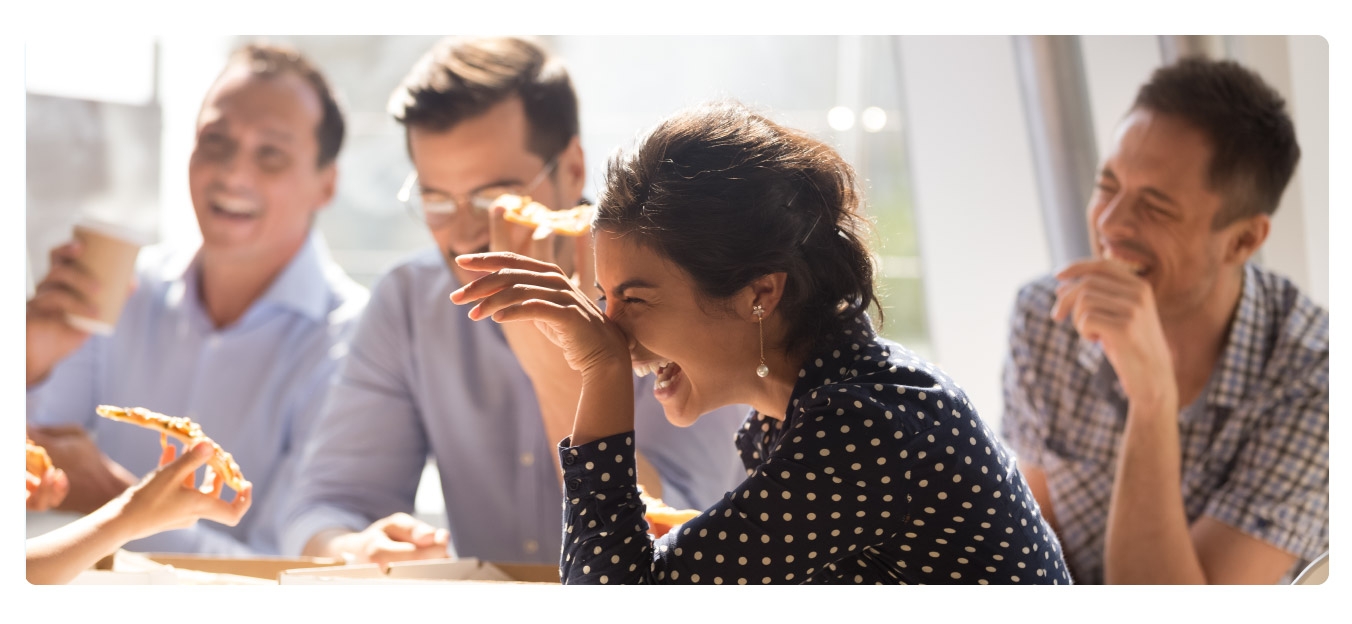 Photo of employees having an office party and team lunch to celebrate a work anniversary.