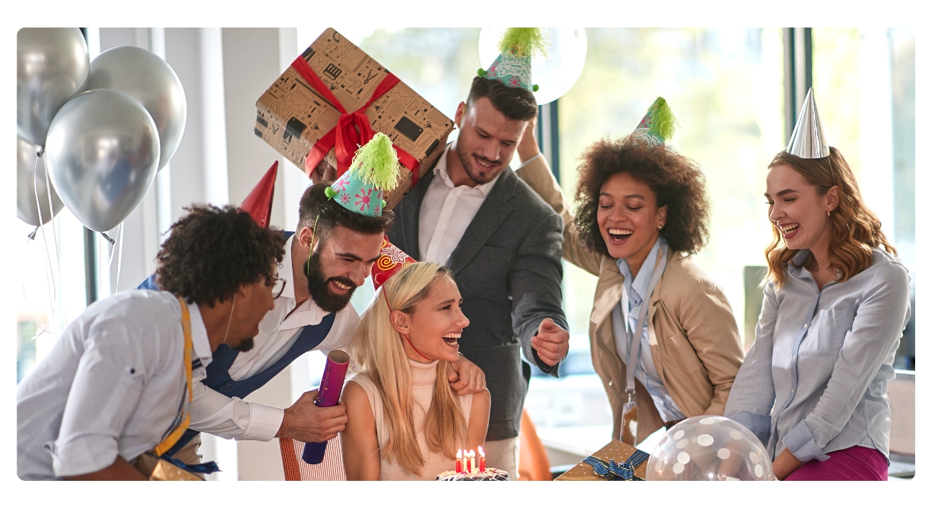 Image of a group of coworkers celebrating an employee milestone, like a birthday or work anniversary.